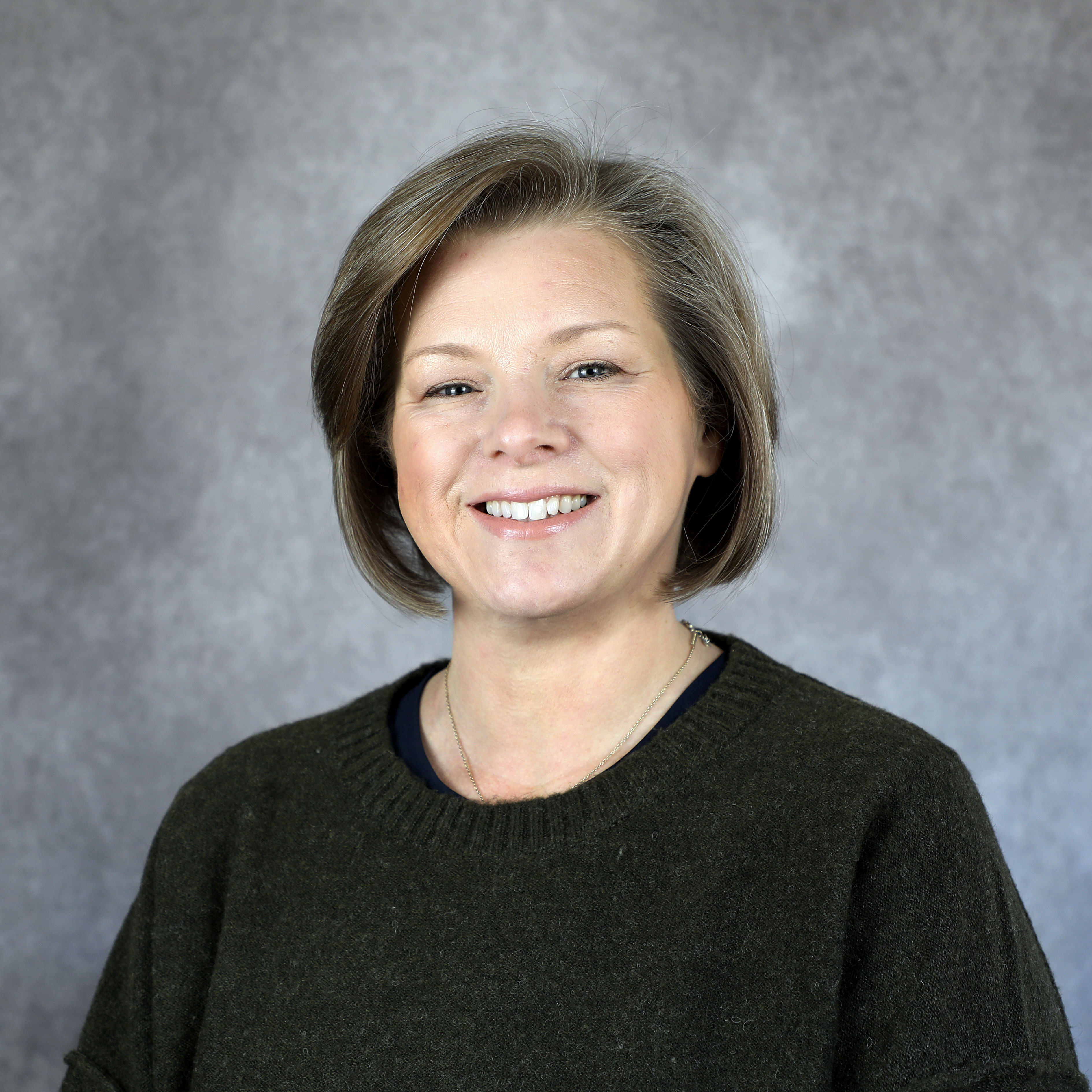 headshot of woman in black sweater