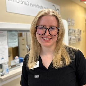 woman wearing glasses and black scrubs